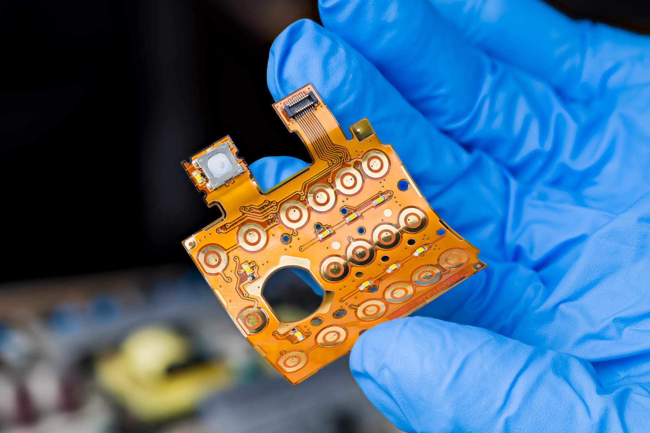Closeup A Flexible Printed Circuit Of Keypad Membrane On Engineer Hand In Blue Glove